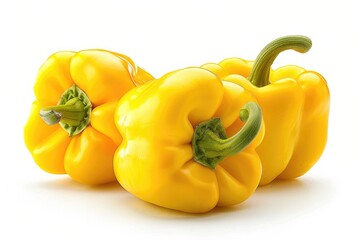 Wall Mural - Three yellow bell peppers arranged on a clean white surface