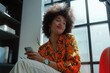 © vefimov - A young, stylish woman smiling in an office setting.