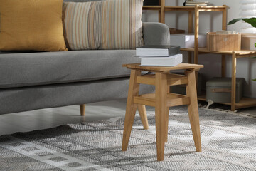 Canvas Print - Wooden stool with books in living room