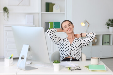 Wall Mural - Smiling businesswoman relaxing at workplace. Break time