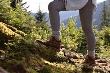 Poster - Young hiker wearing trekking shoes outdoors, closeup