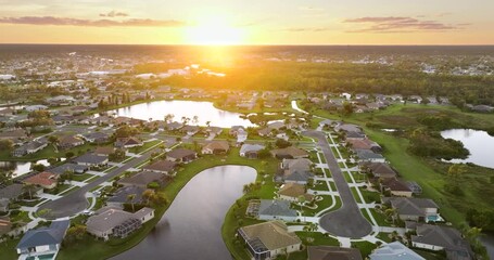 Wall Mural - Wealthy neighborhood with expensive waterfront houses in southern Florida at sunset. Development of US premium housing market