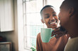 © Frank Coop/peopleimages.com - Relax, bonding and black couple drinking coffee with smile and tea in house for love, talking and laughing. Beverage, break and happy African people in kitchen together to chill in lounge in Kenya