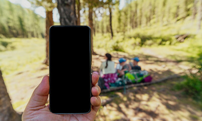 person holding a phone on campsite