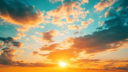 An evening sunset with vibrant orange and golden sunlight illuminating the sky, as fluffy clouds stretch across the horizon over the sea. 