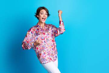 Wall Mural - Photo of overjoyed lovely girl wear stylish clothes rejoice achievement career promotion empty space isolated on blue color background