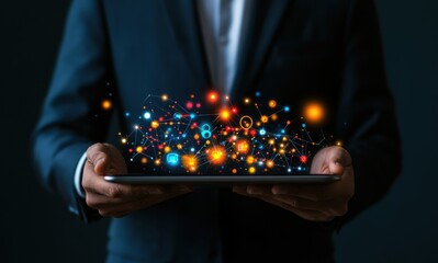 Wall Mural - Businessman holding a tablet with glowing digital network and data visualization, showcasing modern technology and innovation