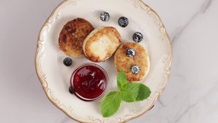 Canvas Print - cottage cheese with jam and berry on plate top view rotation food