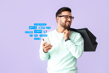 Poster - Handsome man with mobile phone and shopping bags on lilac background