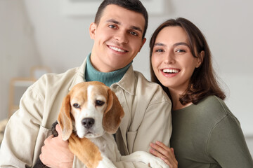 Poster - Young couple with cute Beagle dog at home, closeup