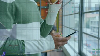 Canvas Print - Animation of financial data processing over african american businessman using smartphone in office