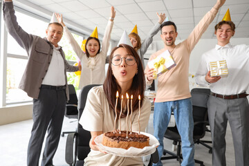 Sticker - Young Asian businesswoman blowing out candles on cake at birthday party in office