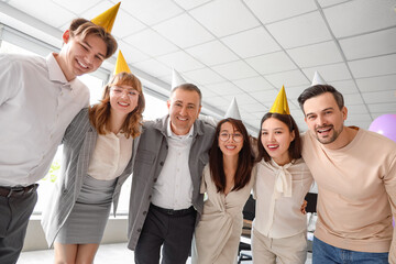 Canvas Print - Group of business people hugging at birthday party in office