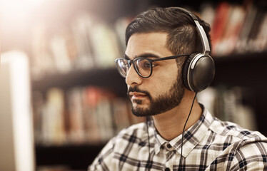 Poster - Computer, headphones and Indian man in library for reading, elearning and education at university. Research, study and college student on campus streaming online course, class or webinar at academy