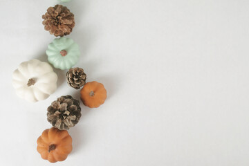 Wall Mural - Modern and minimal style fall season banner with pumpkins and pine cones isolated on white background.