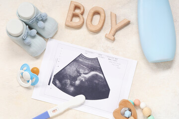 Wall Mural - Composition with baby shoes, sonogram image, pregnancy test and word BOY on grunge beige background