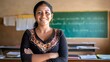 © Peludis - Mexican teacher in the classroom smiles at the camera, behind her are her students, she is proud of teaching elementary school children