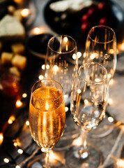 Poster - Glasses of sparkling wine or champagne served on the table for Christmas or New Year eve celebration.