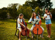 © StarDweller/peopleimages.com - Family, music and trio outdoor for practice, talent and rehearsal for event. Mother, children and classical performance in nature for learning, bonding and string instruments for skill development