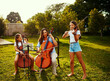 © StarDweller/peopleimages.com - Family, music and trio outdoor for performance, practice and rehearsal for event. Mother, children and talent show in garden for learning, entertainment and string instruments for skill development