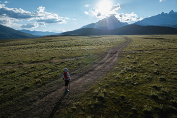 Poster - Aerial view of woman trail runner in high altitude mountains