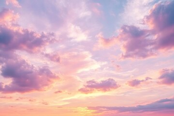 soft pink clouds and yellow tones illuminate the morning sky at sunrise, creating a tranquil and bea