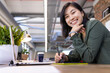 © Wavebreak Media - Smiling asian woman using digital pen and tablet while working in modern office