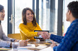 © Wavebreak Media - Shaking hands, woman with tablet making agreement with colleagues in office