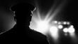 © Jeannaa - Silhouette of a police officer with lights in the background, representing authority and law enforcement in a dramatic scene.