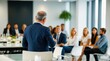 © VistaVisions - Confident businessman giving a presentation in front of crowd in meeting conference seminar room. Leadership authority teamwork in business concept