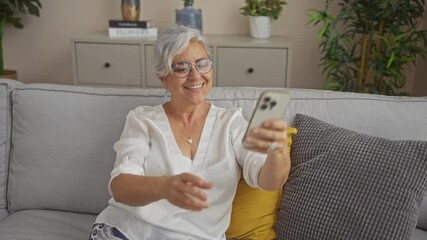 Poster - Woman self-portrait grey-haired smartphone living room white blouse mature home relaxing interior