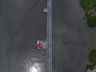 Aerial top view of bridge road with cars over Sea. Resting place the cars stop various types of  Cars in parking lot the highway. Top view Bridge seaside road