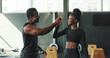 © peopleimages.com - Break, fitness and high five with black people in gym for challenge, sports training or workout. Smile, success or support with athlete and person trainer in health club for exercise goals or target