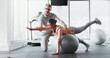 © PeakPoints/peopleimages.com - Ball, girl and personal trainer in gym for fitness, rehabilitation or stability training. Man instructor, woman or physiotherapy in yoga center for core strength, pilates practice or help in exercise