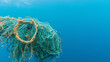 © spr0ut7 design - wad of discarded fishing debris including nets in a clump of trash under the ocean's surface