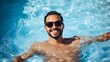 © Jiraphat - Joyful man swimming in clear blue pool, wearing sunglasses, enjoying a sunny day surrounded by water and playful vibes.