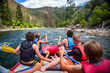 © Brocreative - A large group of men and boys on a white water rafting trip down the Colorado River. View from behind of as they seek adventure and fun.