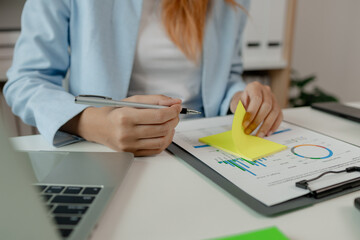 a businesswoman is working in her office, an entrepreneur works on new project in a workplace, a female employee is working in big company in her nice office, strategy and idea