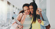 © PeakPoints/peopleimages.com - Friends, happy and excited in university for hug, storytelling and good news on phone. Students, support and mobile in hallway for admission, unexpected notification or acceptance to higher education