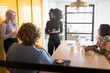 © Johnér - Male and female business professionals discussing in meeting at office