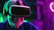 © AURA COLLECTIONS - Senior man with gray hair and beard wearing a VR headset and looking at the camera. The background is out of focus and has a purple and green glow.