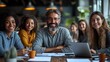 © Boy photographer - Middle-aged businessman In work clothes, sitting around a table Meeting in the office with laptops and computer monitors as they discuss marketing campaign plans together