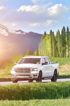 White pickup truck driving on rural road