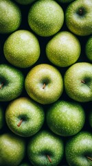 Wall Mural - A captivating close-up showcases an array of fresh green apples from above, highlighting their smooth skin and rich colors in vibrant detail