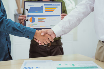 Wall Mural - Close-up of business people shaking hands during a meeting in the office. The discussion revolves around digital marketing management, financial analysis, business writing, teaching,venture capital