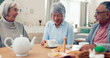 © David/peopleimages.com - Happy, tea and senior friends at table for funny conversation, snacks and retirement together in house. Group, party and man speaking with elderly women smile for breakfast, communication and bonding