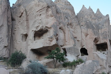 Caves in limestone (sandstone) mountains with rock-cut churches, chapels and monasteries and blue sky in summer in Zelve Open Air Museum, Cappadocia, Anatolia, Turkey (Zelve Açık Hava Müzesi)