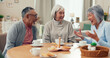© peopleimages.com - Laugh, tea and senior friends at table for funny conversation, snacks and retirement together in house. Group, party and man speaking with elderly women smile for breakfast, communication and bonding