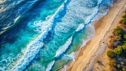 Aerial view of a tranquil blue beach with ocean waves crashing