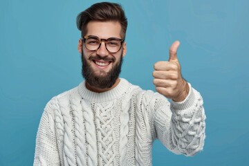 Young man in casual attire and glasses giving thumbs up.